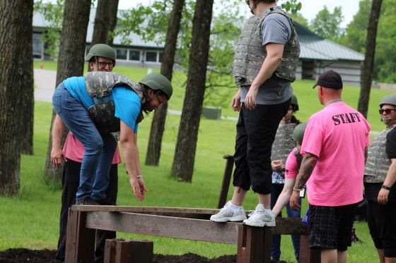 Participants of varying age and size work together to conquer obstacles.
